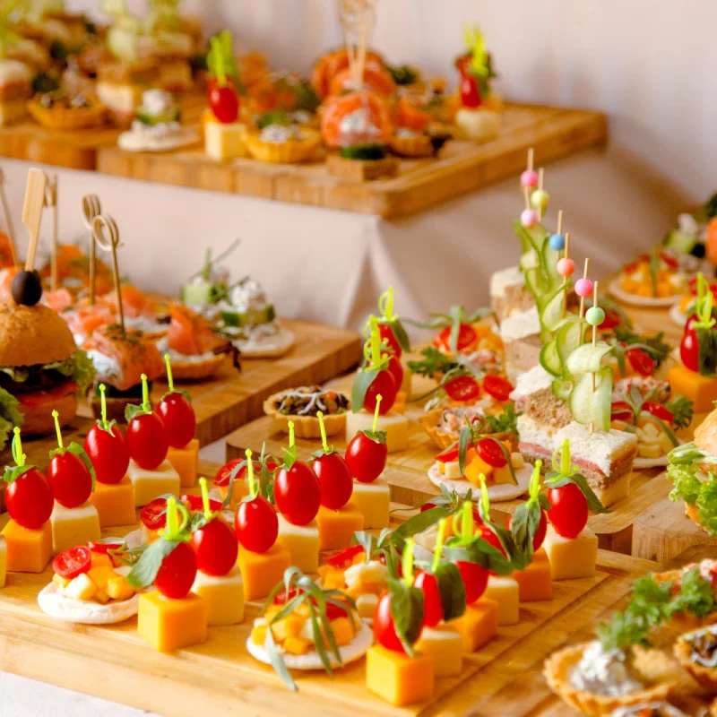buffet table with snacks from burgers cheeses etc